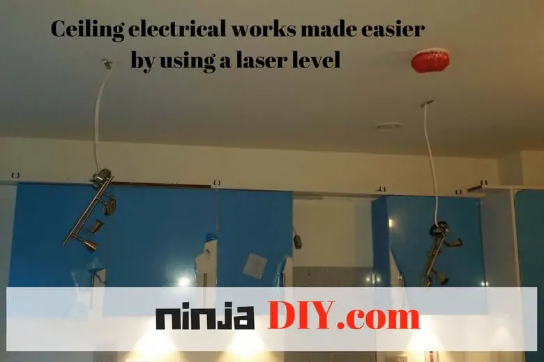 hanging ceiling accessories using a laser level makes electricians jobs easier